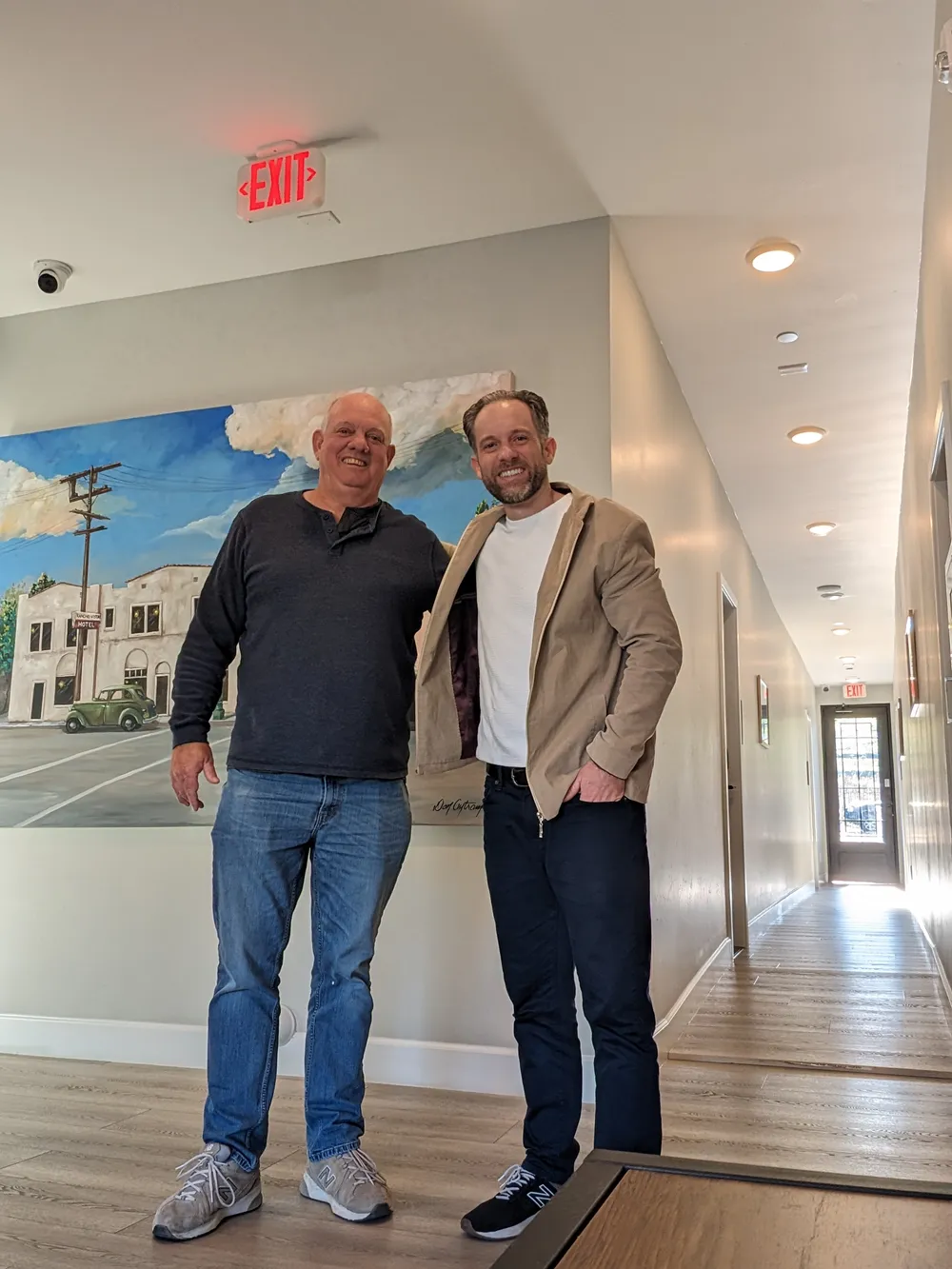Alan Pickering with Tim Hubbard, Co-CEO of Corzly, in the hallway of Alan's boutique hotel
