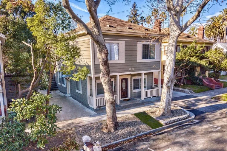 Restored city fourplex on a tree-lined street