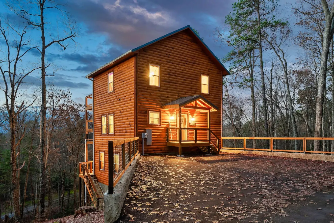 Partner cabin at dusk with the porch lights on